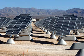 The solar power array at Nellis Air Force Base uses tracking devices to keep the solar panels pointed toward the sun. Tilted toward the south, each set of solar panels rotates around a central bar to track the sun from east to west.