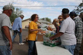 Diane Dempsey, social services director for the Gila Bend Community Action Program, helps distribute the food to families living in a food desert that covers hundreds of square miles southwest of the Valley.