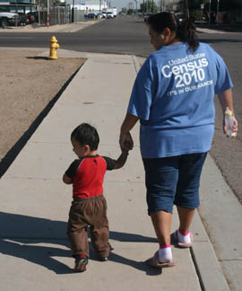 Tina Zamora, who receives Supplemental Nutrition Assistance Program benefits, walks with her grandson in her south Phoenix neighborhood. The area is considered a food desert by the U.S. Department of Agriculture because it lacks convenient access to a supermarket or grocery store offering healthy, affordable food.