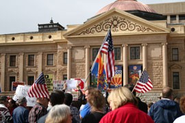 Supporters and opponents of SB 1070 rally in front of the State Capitol.