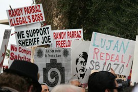 Supporters and protestors rally at the State Capitol during a news conference at which a Democratic state lawmaker discussed a bill to repeal SB 1070.