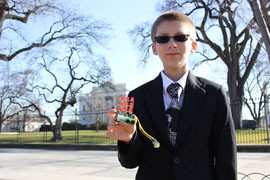 Joe Hudy in front of the White House with his LED Cube Microprocessor Shield, one of two inventions the Phoenix teen showed off at the second annual White House science fair. He also sells the cube online as part of a small business he started.