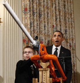 President Barack Obama reacts as Phoenix teen Joey Hudy launches a marshmallow from his Extreme Marshmallow Cannon in the State Dining Room during the second annual White House Science Fair, which honors student winners of science, tech, engineering and math (STEM) competitions from across the country.