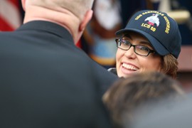 Gabrielle Giffords chatted with well-wishers at the Pentagon, where she donned a hat with the logo of the new Navy ship that will be named in her honor.