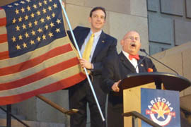 Secretary of State Ken Bennett and Don Shields, affiliated with the Arizona Capitol Museum, stand on the steps of Historic City Hall to display a U.S. flag with 48 stars, signifying Arizona's place at the 48th state.