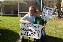 Jay Baker brought his 4-year-old son, Henry, to protest.