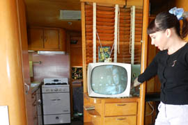 Jennifer Luria, owner, turns on a television set in one of the hotel trailers at the Shady Dell in Bisbee. The sets are still fixed by a repairman in the Valley who knows how to repair vintage TVs.