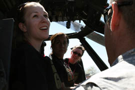 From left, Courtney Miller and Viviana Jacques, both from the community outreach office of the Arizona Attorney General's Office, and Nicole Krug look at the inside of a UH-60 Blackhawk helicopter.