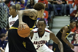 The University of Arizona's Kyle Fogg, 21, focuses during the Wildcats Dec. 31 game against Arizona State University's Sun Devils.