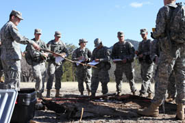 Junior cadets take note as senior cadet Steven Wilson, far left, leads a land navigation exercise.