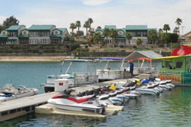 Boats line the dock at the channel of Lake Havasu. Rentals for water accessories get a major jump when spring break comes around.