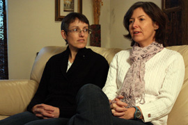 Carrie Sperling and Sue Shapcott are shown in their Phoenix home in February 2011. Sperling, right, an Arizona State University employee, is a plaintiff in the lawsuit seeking to block the state law that would deny benefits to same-sex partners of state workers.