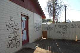 National Fair Housing Alliance investigators visited this bank-owned property in the predominantly Hispanic Maryvale neighborhood in November. Their report said the home was covered in graffiti and had broken and boarded-up windows.