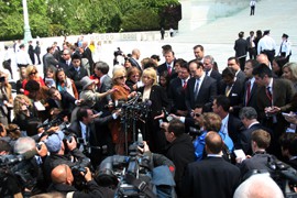Arizona Gov. Jan Brewer is surrounded by reporters after the Supreme Court's hearing on SB 1070.