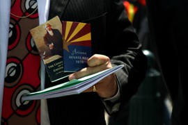 The Constitution and SB 1070, the keys to the Supreme Court hearing over Arizona's immigration law. They are held here by former state Sen. Russell Pearce outside the court at April's hearing.