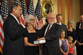 House Speaker John Boehner at a ceremonial swearing-in of new Arizona Rep. Ron Barber, D-Tucson, while Barber's wife Nancy holds a Bible for the event.