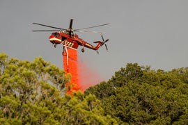 A sky crane drops retardant on the Whitewater-Baldy Fire in New Mexico in May. Firefighters say forecasts like NOAA's let them determine where best to deploy gear at the beginning of a season.