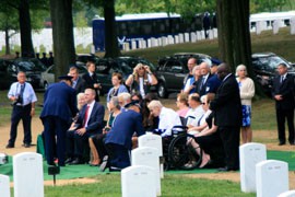 Air Force officers present flags to the families of Lt. Col. Charles M. Walling of Phoenix and Maj. Aado Kommendant, who went missing in action over Vietnam 46 years ago. The men, whose remains were recently identified, were given a group burial ceremony at Arlington National Cemetery.