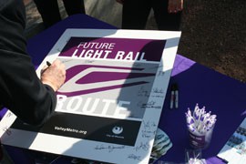 Officials autograph a sign unveiled Thursday that will mark a 3.2-mile stretch of north Phoenix that will be the route of a Metro light-rail extension.