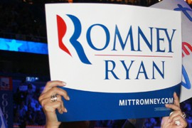 A convention-goer waves one of the hundreds of signs supporting Mitt Romney and running mate Paul Ryan at the Republican National Convention.
