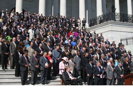 Members of Congress bow their heads in a moment of silence on the East Front of the Capitol during a ceremony on the 11th anniversary of the 9/11 attacks.