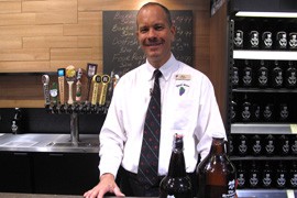 Mark Massimi, manager of a Total Wine and More outlet in Phoenix, displays growlers that his store can fill with craft beer under a new state law.