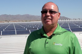 Albert Laird, SolarCity's regional vice president, stands in front of 1 million square feet of solar panels his company installed atop a Walmart distribution center in Buckeye. He says solar has become a major industry in Arizona.