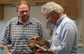 Dr. Stephen Jackson, Director of the U.S. Department of the Interior Southwest Climate Science Center (right) reviews a 7,000 year old specimen containing organic materials, while Doug Beard, Chief of the USGS National Climate Change and Wildlife Science Center (left) observes.