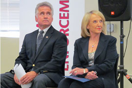 Gov. Jan Brewer and Superintendent of Public Instruction John Huppenthal listen to a speaker at a news conference on Wednesday, promoting new Common Core standards for math and English.