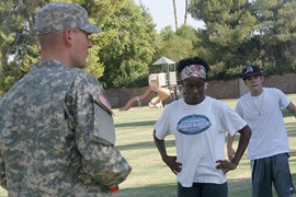 Kandice Talley (foreground) exercises along with other military enlistees at a park in Goodyear.
