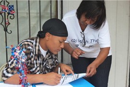 Miara Hunt, 19, registers to vote with the help of Debbie Agee (right) during a registration drive outside the Thomas Deli in Pratt City, Ala.