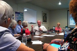 Charles Spencer speaks during a meeting at the Adult Loss Of Hearing Association's headquarters. The room is looped to connect sound collected by microphones to hearing aids.