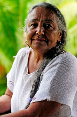 Naniki Reyes Oscario, a Taino Indian elder in Puerto Rico, poses for a portrait outside her home in the central mountains. Oscario said she is frustrated because despite cultural and historical recognition as an indigenous community, the Taino nation is not federally recognized by the governments of the United States and Puerto Rico.