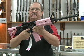 Owner Ron Sega shows an AR-15 assault rifle for sale at Guns Etc. in Chandler. He said sales are up of late in large part because of buyers' concerns about the potential for new gun laws in President Barack Obama's second term.