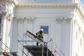 A worker assembles scaffolding on the West Front of the U.S. Capitol as crews work to build seating and a swearing-in platform for the Jan. 21 inauguration ceremony.