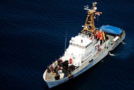 The U.S. Coast Guard cutter Chincoteague, seen here from a HH65-A Dauphin helicopter, interdicted a group of migrants the night before as they tried to enter Puerto Rico on a vessel from the Dominican Republic. Although most of the migrants will be sent back to the Dominican Republic, the Coast Guard said at least five from the group would face prosecution in the U.S.