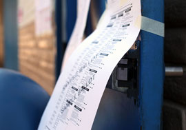 A sample ballot hangs outside the polling precinct Tuesday at Peralta Elementary school in west Phoenix.