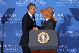 President Barack Obama thanks Brian Cladoosby, chairman of the Swinomish Tribe of Washington State, after Cladoosby jokingly introduced Obama on Wednesday as the first Native American president of the United States.
