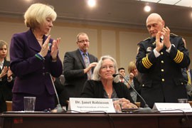 Emily Nottingham is applauded at a congressional hearing where she testified about her son, Gabe Zimmerman, one of six people killed in a 2011 shooting in Tucson that also wounded 13 people, including then-Rep. Gabrielle Giffords, D-Tucson.