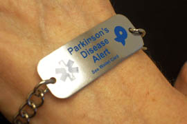 Beth Lee, 62, shows a bracelet identifying her as a Parkinson's patient.