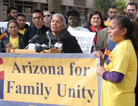 Petra Falcon, executive director of Promise Arizona, speaks at a news conference Monday outside the State Capitol. She said national immigration reform must include keeping families together and providing a pathway to citizenship.