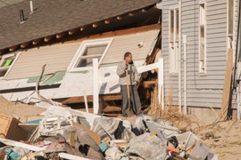An Ortley Beach, N.J., resident takes a break from cleaning up the remains of his home in November, several weeks after it was damaged when Superstorm Sandy swept through the area.