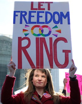 A supporter of same-sex marriage makes her feelings none at the Supreme Court, on of thousands who came out to demonstrate as the justices took up two cases concerning gay marriage. Lawyers say it's hard to predict how the cases will affect a pending Arizona case.