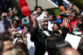 An Iranian immigrant celebrates her new U.S. citizenship at a ceremony in Seattle on July 4, 2012. A new report finds that Mexicans in the U.S. opt for naturalization at a little more than half the rate of all other immigrants.