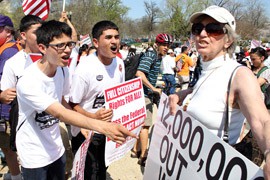 Joyce Tarnow, an opponent of comprehensive immigration reform, makes her position known at a pro-reform rally, drawing jeers from reform supporters.