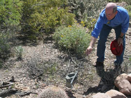 Randy Babb, information and education program manager for the Arizona Game and Fish Department's Mesa region, demonstrates how a rattlesnake, at lower left, responds to a perceived threat.