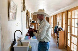Moroney washes his hands after feeding the goats on his southern Airzona ranch. His property comes within 20 miles of the border fence.