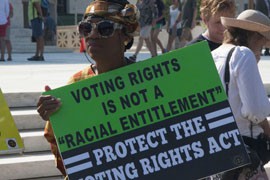 A protester makes her opinion known at an NAACP rally after the Supreme Court held that part of the Voting Rights Act was unconstitutional.