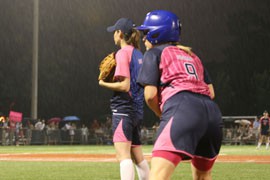 Rep. Kyrsten Sinema, D-Phoenix, leans off of first base on a rainy Washington evening during an annual charity softball game between congressional women and women journalists.
