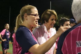 Rep. Kyrsten Sinema, D-Phoenix, talks to other players with House Minority Leader Nancy Pelosi after a team of congressional women played a charity softball against women of Washington's press corps.